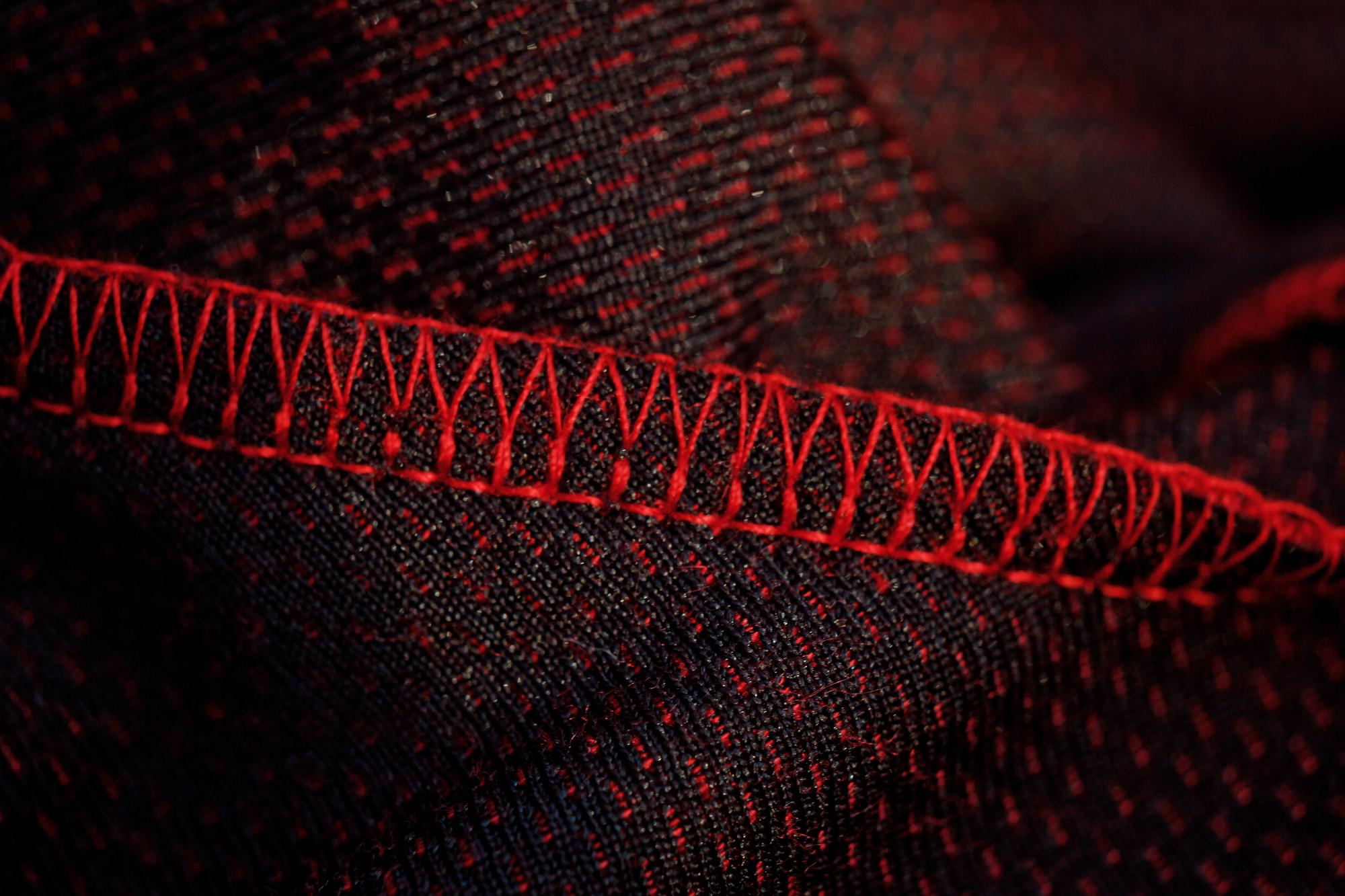 Close-up of blue and silver embroidered circuit pattern on fabric